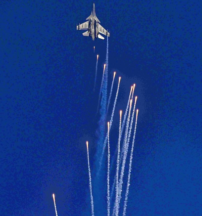 Rafale fighter aircraft of the Indian Air Force fires flares during the 88th Indian Air Force Day celebrations.
